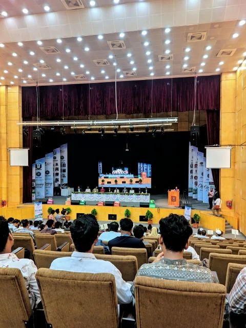 Conference auditorium with a panel on stage and EFAST 2026 banners