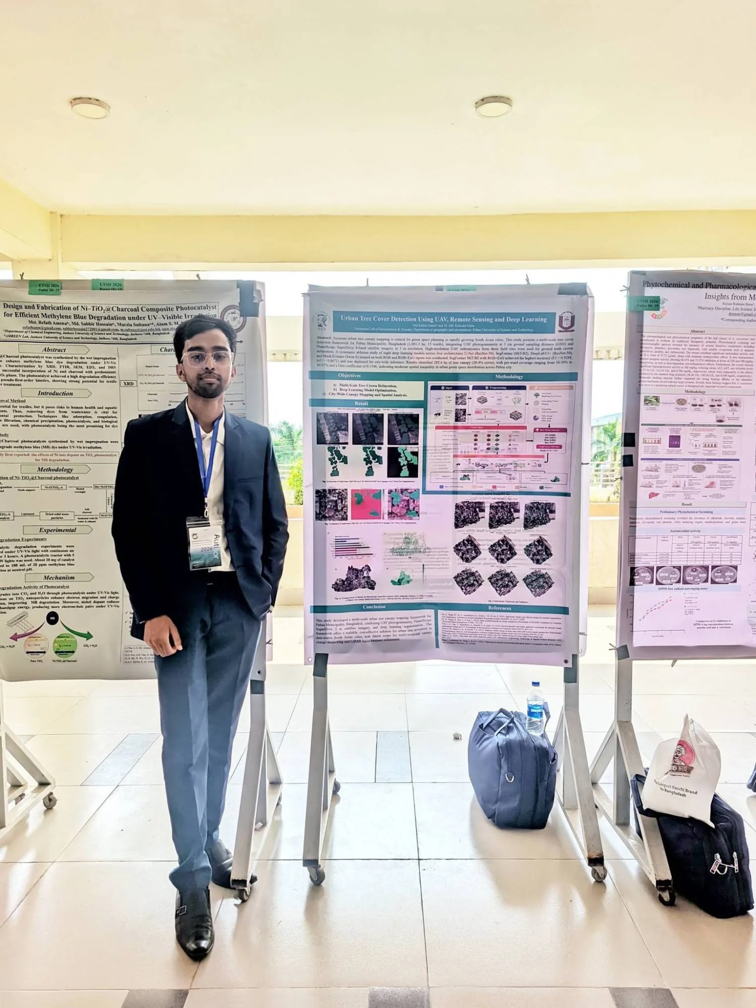 Md Sabbir Islam in a suit with an author badge, standing beside his research poster on urban tree cover detection